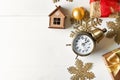 Composition with alarm clock, gifts and decorations on light background. Christmas countdown Royalty Free Stock Photo