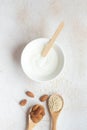 Composition of almonds and sesame seeds in wooden spoons. Royalty Free Stock Photo