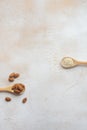 Composition of almonds and sesame seeds in wooden spoons. Royalty Free Stock Photo