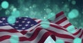 Composition of american flag billowing over defocussed bokeh blue lights on sunset sky Royalty Free Stock Photo