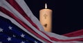 Composition of american flag and lit candle with christian cross on black Royalty Free Stock Photo