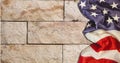 Composition of american flag on pale stone wall
