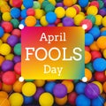 Composition of april fools day text over multi coloured balls