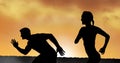 Composition of athletic male and female silhouettes running over sunset