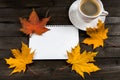 Composition with autumn leaves, blank notebooks, a cup of coffee on a wooden table Royalty Free Stock Photo