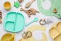 Composition with baby accessories and bibs on white background, top view
