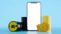 Composition of a barrels of oil with dollar coins and smartphone,