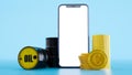 Composition of a barrels of oil with golden euro coins and smartphone,