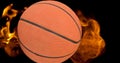 Composition of basketball ball surrounded by flames on black background Royalty Free Stock Photo