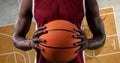 Composition of basketball player holding basketball over basketball court cracked distressed surface