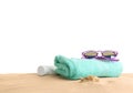 Composition with beach sand, sunglasses and towel on white background
