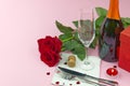 A composition of a beautiful bouquet of roses, glasses and a bottle of champagne creates a romantic card or poster. The concept of Royalty Free Stock Photo