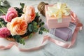 Composition with beautiful flowers and gift boxes on light background Royalty Free Stock Photo