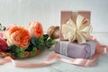 Composition with beautiful flowers and gift boxes on table against light background Royalty Free Stock Photo