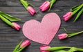 Composition with beautiful tulips and paper heart on wooden background Royalty Free Stock Photo