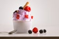 Composition of berries ice cream ball in paper cup Royalty Free Stock Photo