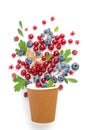 Composition - a berry fountain from a brown cup Royalty Free Stock Photo