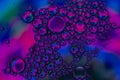 Oil drops on water colors red blue purple Royalty Free Stock Photo