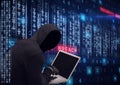 Composition of binary coding and cyber crime warning text over hacker in hood using laptop Royalty Free Stock Photo