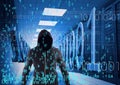 Composition of binary coding over hacker in hood in tech room with computer servers Royalty Free Stock Photo