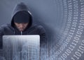 Composition of binary coding over hacker in hood using laptop Royalty Free Stock Photo