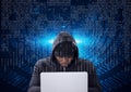 Composition of binary coding over hacker in hood using laptop Royalty Free Stock Photo