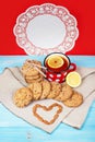 Composition of biscuits, cup of tea, nuts and lemon on the vintage background. Love concept. Royalty Free Stock Photo