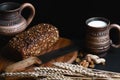 Composition black bread on the board, vintage knife, milk, wheat flakes on the table and the old background, concept of healthy ea Royalty Free Stock Photo