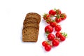 Composition of black bread and bunch of cherry tomatoes Royalty Free Stock Photo