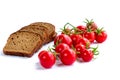 Composition of black bread slices and bunch of cherry tomatoes Royalty Free Stock Photo