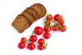 Composition of black bread slices and bunch of tomatoes Royalty Free Stock Photo