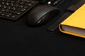 Composition with black pen, computer keyboard, smartphone, leather wallet and bright yellow notebook on dark black surface. Royalty Free Stock Photo