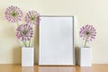 Composition with blank white frame and porcelein two white vases and summuer purple flowers