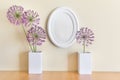 Composition with white oval frame and porcelein two white vases and summuer purple flowers