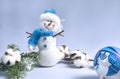 Composition in blue, snowman, spruce branch, cotton branch, blue