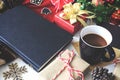 Composition of book with cup of coffee and Christmas decorations on table Royalty Free Stock Photo