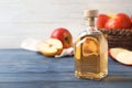 Composition with bottle of apple vinegar on table