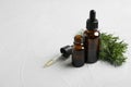 Composition with bottles of conifer essential oil on light background Royalty Free Stock Photo