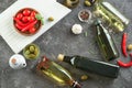 Composition with bottles of olive oil and vegetables on grey background Royalty Free Stock Photo