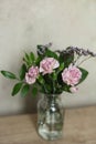 Bouquet of pink carnation flowers in a glass vase on the table Royalty Free Stock Photo