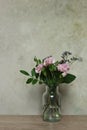 Bouquet of pink carnation flowers in a glass vase on the table Royalty Free Stock Photo