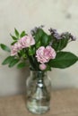 Bouquet of pink carnation flowers in a glass vase on the table Royalty Free Stock Photo