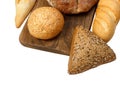 Composition with bread and rolls on cutting board isolated on white Royalty Free Stock Photo