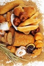 Composition with bread and rolls in wicker basket, combination of pastries for bakery or market with wheat Royalty Free Stock Photo