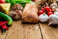 Composition of bread, tomatoes, garlic, cucumber, cheese, pepper, greens, mushrooms on a wooden board