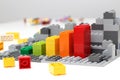 Progress chart made of bricks. Isometric composition of colourful toys on white table. Royalty Free Stock Photo