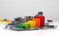 Progress chart made of bricks. Isometric composition of colourful toys on white table. Royalty Free Stock Photo