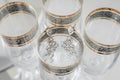 Composition of bride earrings on the vintage stylish glasses. Royalty Free Stock Photo