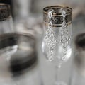 Composition of bride earrings on the vintage stylish glasses. Royalty Free Stock Photo