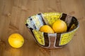 Composition of bright ceramic bowl and yellow lemons. Royalty Free Stock Photo